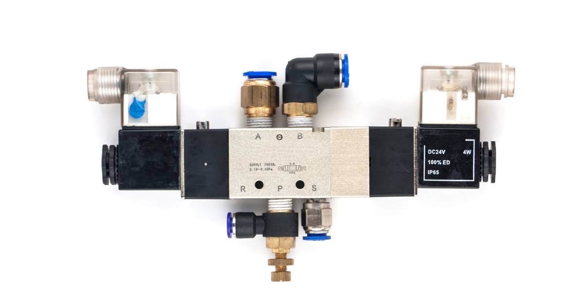 A pneumatic valve against a white background. Many different ports are attached to the valve.