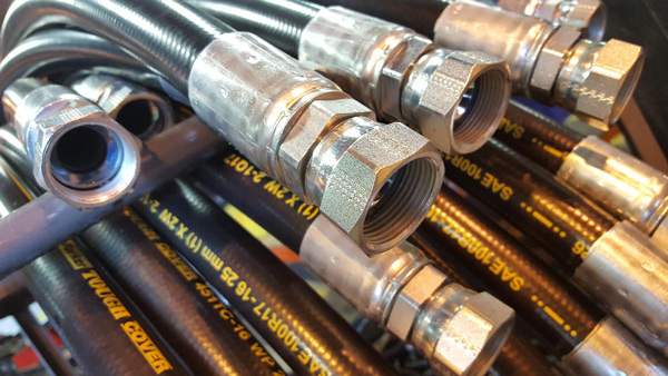 Hydraulic hose assemblies, ready on a cart and waiting to be put into action. Image